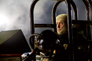 A determined and focused Louis Haney waits in line for the pull, wearing his fire-resistant hood. He drives the diesel version of Cujo, a tractor well-known for decades in pulling circles.