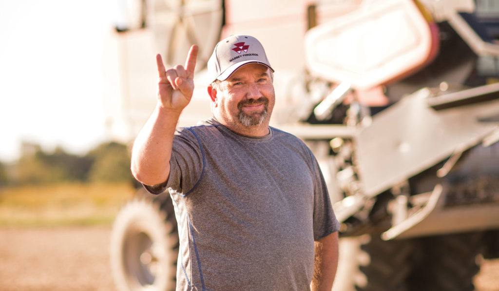Dave Lynn, A farmer from Illinois stands in front of a high-tech tractor.