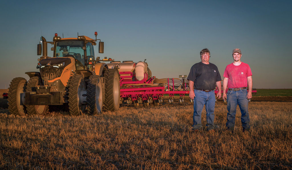 Robin Olson and son, Joseph, with their new Challenger 1042 tractor.