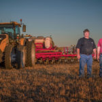 Robin Olson and son, Joseph, with their new Challenger 1042 tractor.