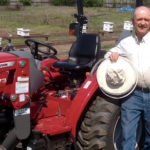 Jim Ellis and his Massey Ferguson 1734E utility tractor.